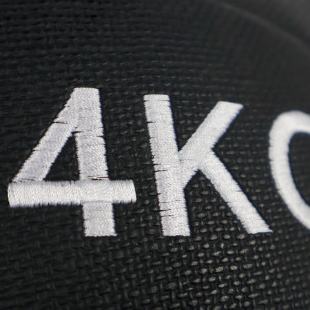 Black wall ball  plate with '4KG' embossed on it