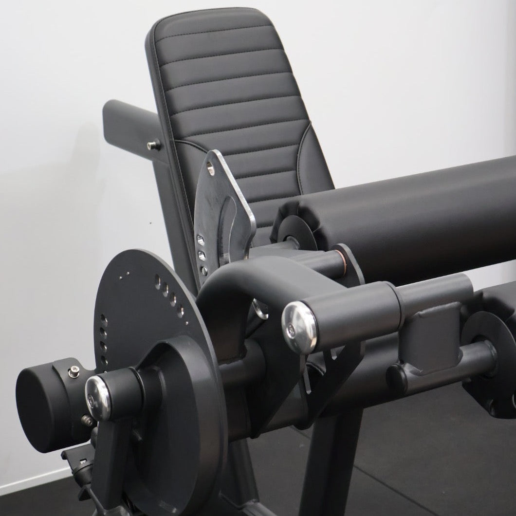Leg extension and leg curl exercise machines