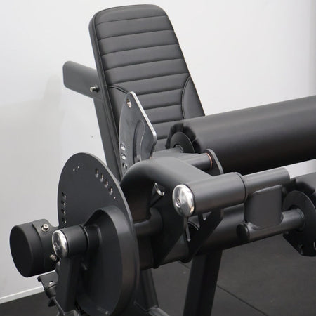 Leg extension and leg curl exercise machines