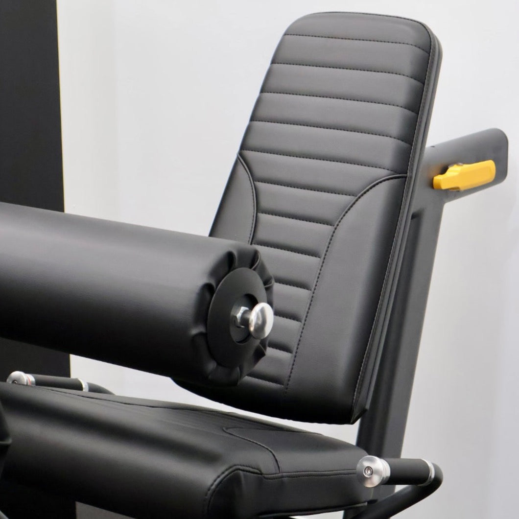 Leg extension and leg curl exercise machines
