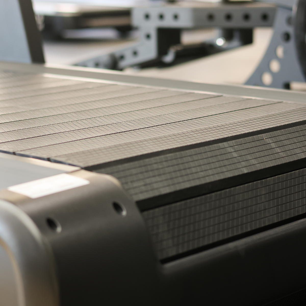 Close-up of a robotic arm interacting with a metallic surface