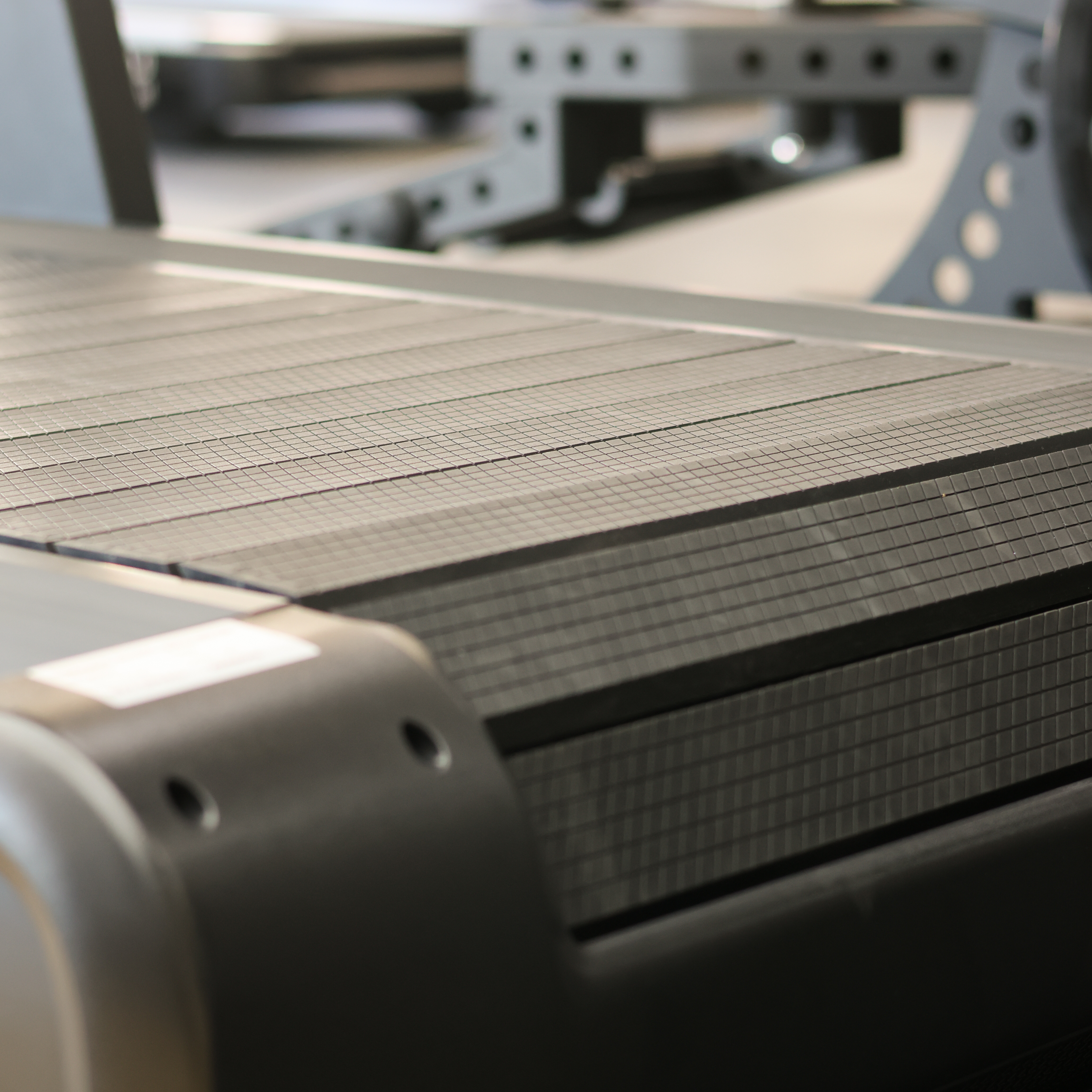 Close-up of a robotic arm interacting with a metallic surface