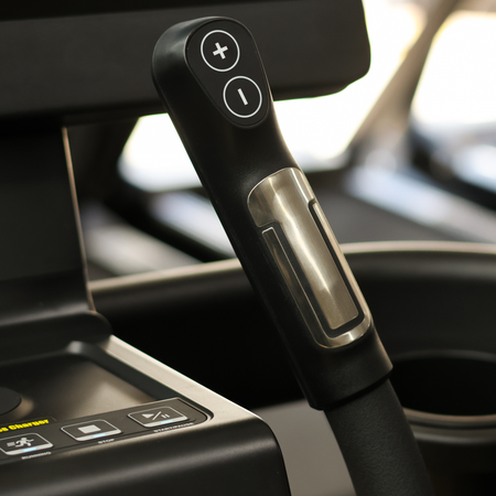 Close-up of a car audio control knob with blurred interior background
